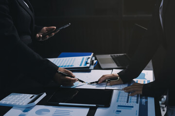Teamwork with business people analysis cost graph on desk at meeting room. double exposure...