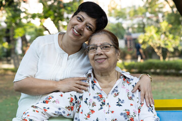 Fototapeta premium Close up shot of senior mother and daughter embracing at park