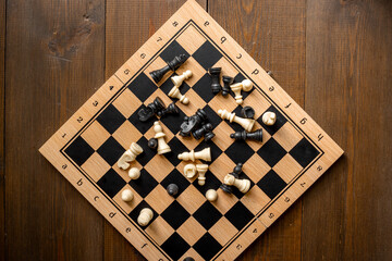 White and black chess pieces on chessboard during the game, top view