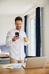 Man multitasking with phone and working at home office