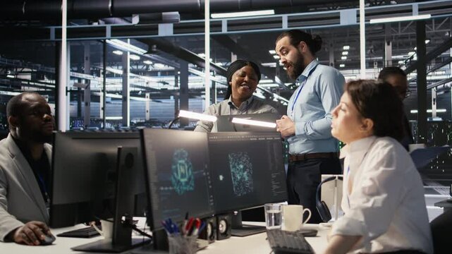 Data center engineering team colleagues collaborating on blade servers maintenance to ensure continuous AI processing. Technicians manage infrastructure supporting machine learning pipelines, camera A