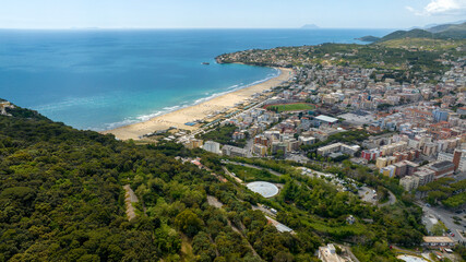 Obraz premium Aerial view of Serapo bay overlooking the Mediterranean Sea. It is the main beach of Gaeta, in the province of Latina, Lazio, Italy. In background there is Ponza island.
