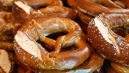 Freshly baked pretzels on a bakery stall at a food market