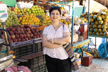 Indian woman purchasing vegetables on grocery market