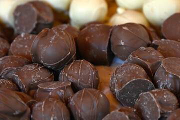 Closeup of artisanal milk and white chocolates on a confectioners stall at a food market