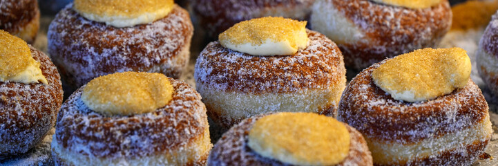 Closeup of donuts on a bakery stall at a food market