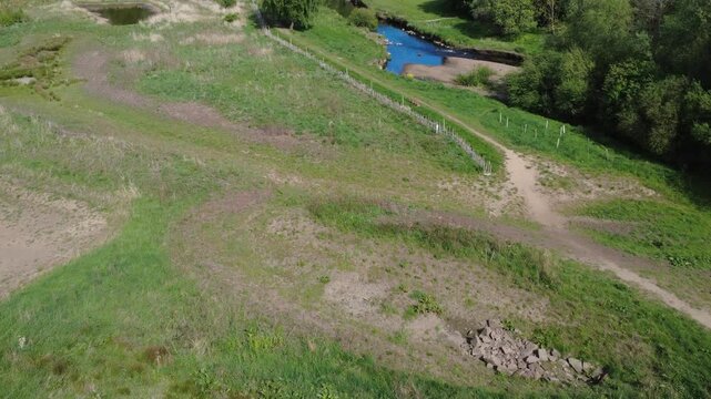 scenic aerial drone shot of the river calder at Brearley fields wetlands between mytholmroyd and Luddenden Foot showing the area surrounding the riverbank