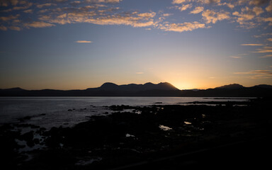 Views out across Gruinard Bay towards the summit of An Teallach at sunrise in the North West Scottish Highlands in the UK