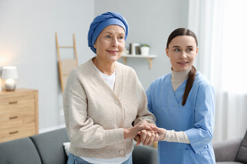 Nurse supporting woman with cancer at home