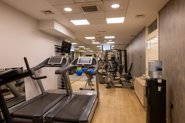 Fototapeta premium Modern fitness gym with equipment and mirrors