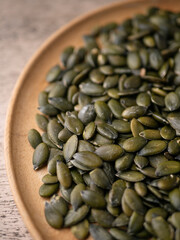 Peeled dry pepita pumpkin seeds background.