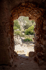 View from inside a medieval stone tower in Vila Velha de Ródão, Portugal, revealing the rugged natural landscape. Captured during summer to highlight historical and architectural heritage.