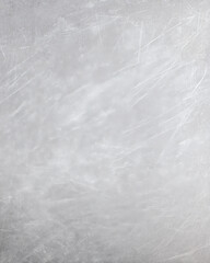 An abstract view of a textured silver metal surface shows scratches and imperfections offe a modern artistic background with an industrial aesthetic quality.