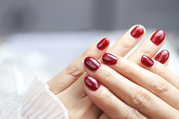  woman hands with colorful red and decorated nail manicure with modern, innovative and elegant shapes. Nails and manicure.