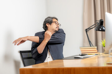 Work-life balance in action, a businessman takes a moment to stretch and relieve tension after...