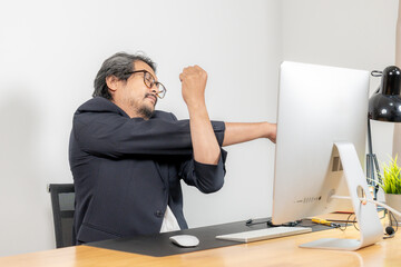 Work-life balance in action, a businessman takes a moment to stretch and relieve tension after...