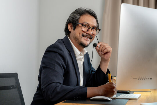 Focused and engaged — a young professional in headphones participates in a virtual business meeting