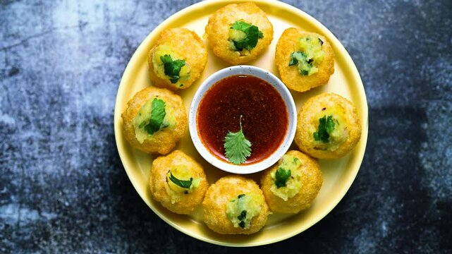 Close up of Indian street food fuchka on a glass with sour spicy water.  Pani puri a chat item in India. 4K indian street food snacks.
