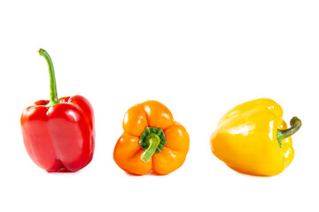 Fresh juicy shiny red, yellow and orange bell peppers. Isolated on white.