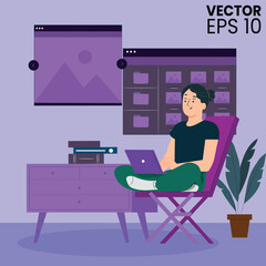 A man doing working on computer and laptop while sitting on chair.