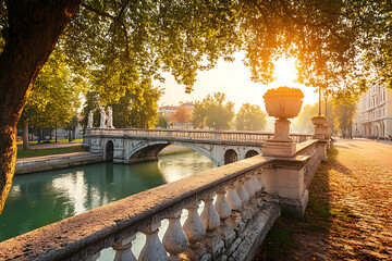 Serene sunrise scene over a classic bridge spanning a calm river, with stone balustrades and trees framing the picturesque view