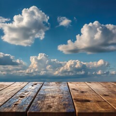 Wooden tabletop against a blue sky with fluffy white clouds