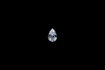 Pear shaped diamond isolated on black background, a precious gemstone