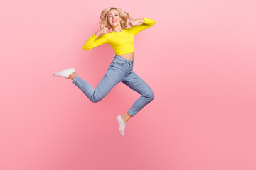 Full body cadre of energetic youngster woman blonde curls thumbs up wear denim shirt jeans fashion...