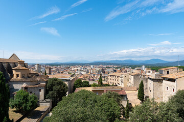 Fototapeta premium Landscape of Girona from the distance with mountains in the background on a nice day of summer