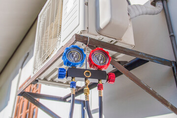 Air conditioner technician checking air conditioner operation	