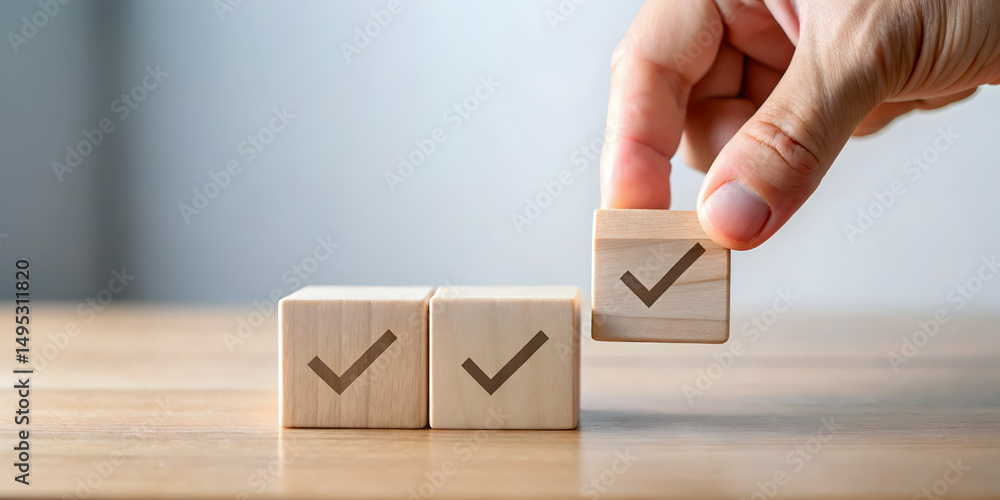 Poster hand placing wooden block with checkmark completing a row of three on a table