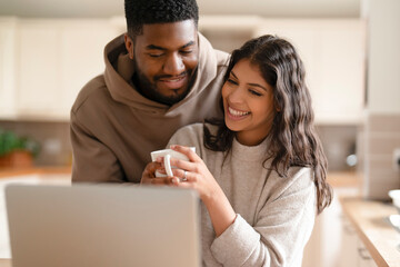 Couple enjoying coffee together while working from home in a cozy kitchen setting during daytime