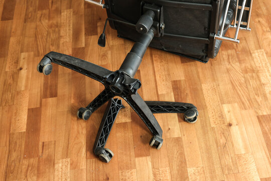 An office chair floor with broken legs: a symbol of poor workmanship and the need for repairs.