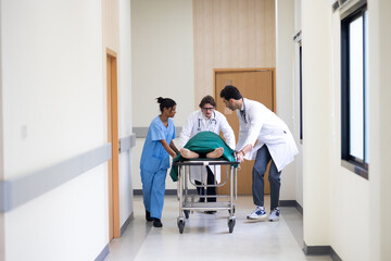 emergency hospital, Group of diverse man and woman medics or doctors Push Stretcher with Seriously Patient to Operating Room, Emergency Department