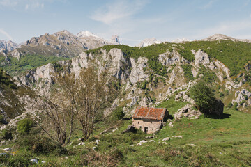 Secluded Stone House Nestled in Green Hills of Majada de Tobaos with Naranjo de Bulnes and Picos de Europa Peaks in the Background, Asturias, Spain