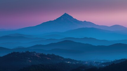 Mountain silhouette under twilight sky, serene blue tones blending into dusk, nature's quiet grandeur