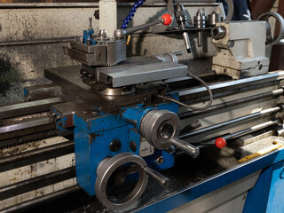 A blue machine with red buttons and a red handle