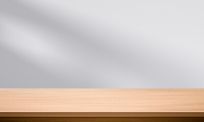 Wood table top and blurred wall shadow leaves window background can used for display or montage your products