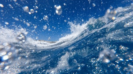 The concept of renewable energy is illustrated by hydrogen bubbles ascending from oceanic electrolysis, set against a blue-green water and sky backdrop