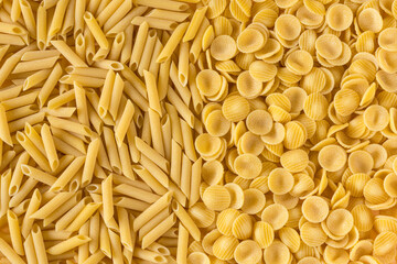 Pasta , flat lay . Various kinds of uncooked pasta , top view . Pasta background  high-resolution .