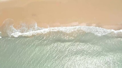 Relaxing ocean waves gently flow on a sandy beach at sunset - Powered by Adobe