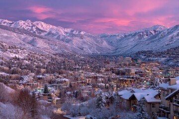 Winter sunset casts a pink glow over a snow-covered valley in Utah