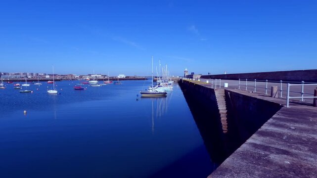 Howth Harbour Stone Pier with Boats and Seaside Town in Background