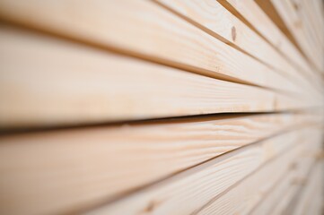 Stack of wooden planks forming a textured background in a construction workshop
