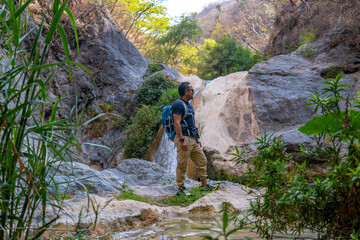 Tourist enjoying the scenic beauty of la magdalena waterfalls in tlatlauquitepec