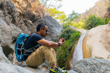 Tourist taking pictures of a waterfall in puebla, mexico