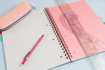 Open blank spiral bound squared notebook with drawing accessories