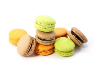 Pile of macaron cookies in various flavours and colours isolated on white background.