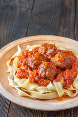 Beef meatballs with tomato sauce served over fresh tagliatelle pasta, Italian style