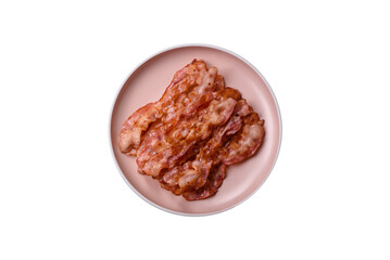 Cooked crispy bacon, slices of roast pork for an English breakfast. Fried bacon